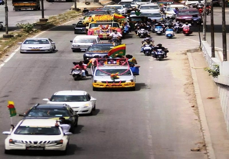 A caravan of vehicles escorting Muthappa Rai