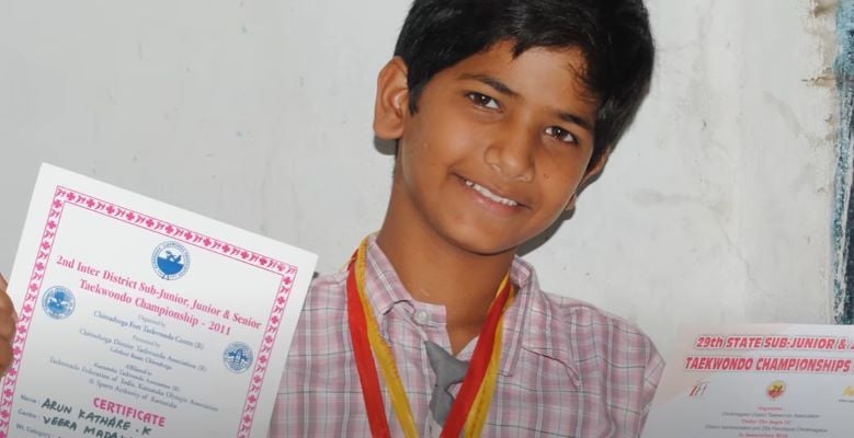 A childhood image of Arun Kathare after winning Taekwondo competitions