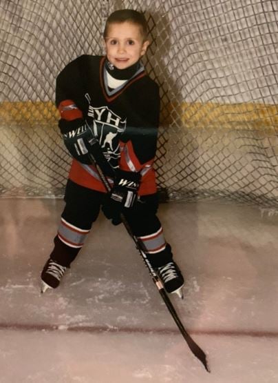 A childhood photo of Devlin Hodges playing ice hockey