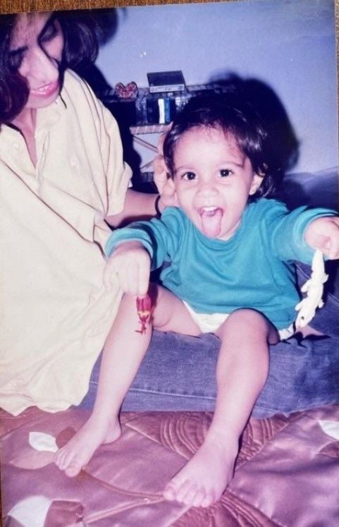 A childhood photograph of Nitya Mathur with her mother