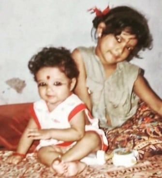 A childhood picture of Amrutha Suresh (right) with her sister