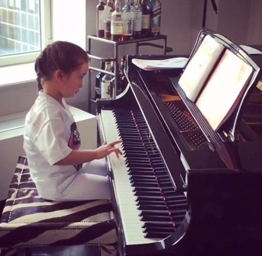 A childhood picture of Arabella Rose Kushner while practising piano at her home