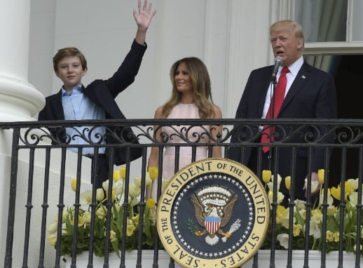 A childhood picture of Barron Trump with his parents at White House