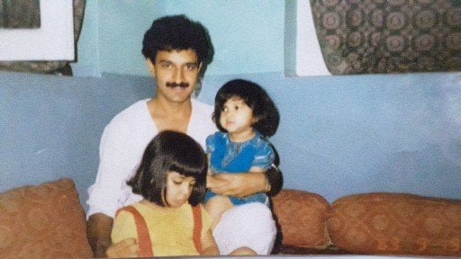 A childhood picture of Iltija sitting on her father