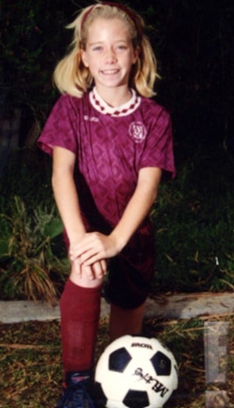 A childhood picture of Kendra Wilkinson posing with Softball
