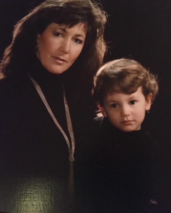 A childhood picture of Penn Badgley with his mother