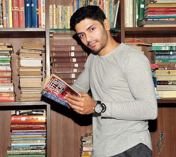 A photo of Arjun Chakrabarty reading a book