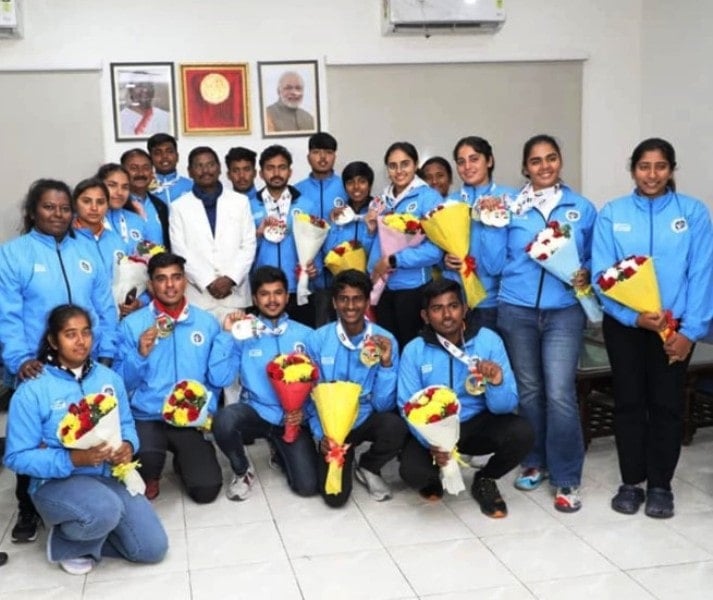 A photo of Arjun Munda taken with the Indian Archers
