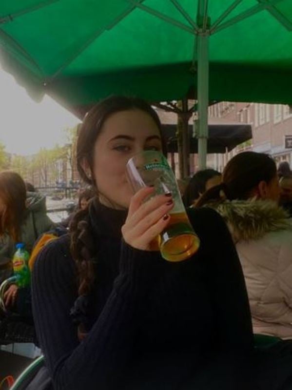 A photo of Maddie Hamilton enjoying her alcoholic drink