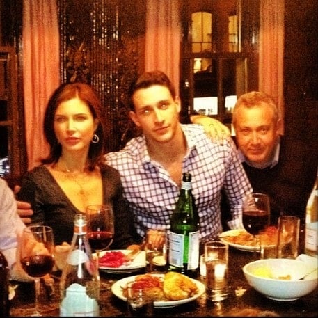 A photo of Mike with his father and sister at a party