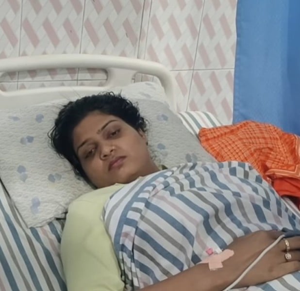 A photo of Nisha Upadhyay resting in the hospital during treatment of bullet wound
