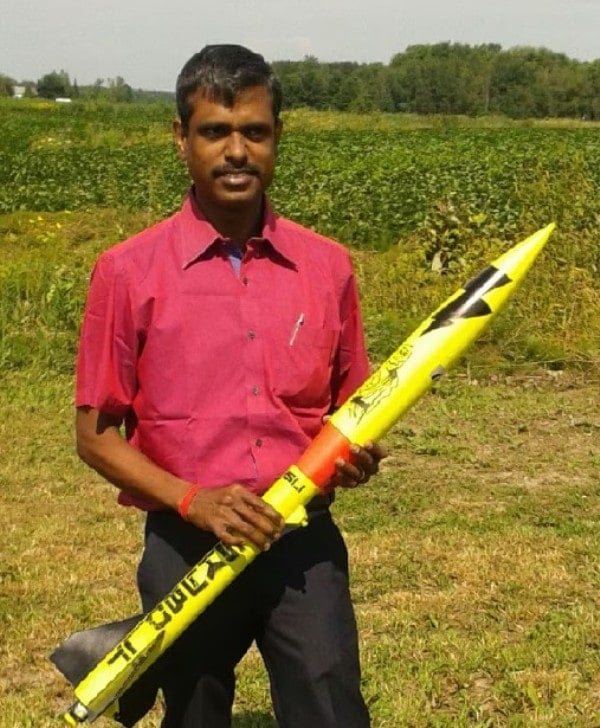 A photo of P. Veeramuthuvel with a rocket