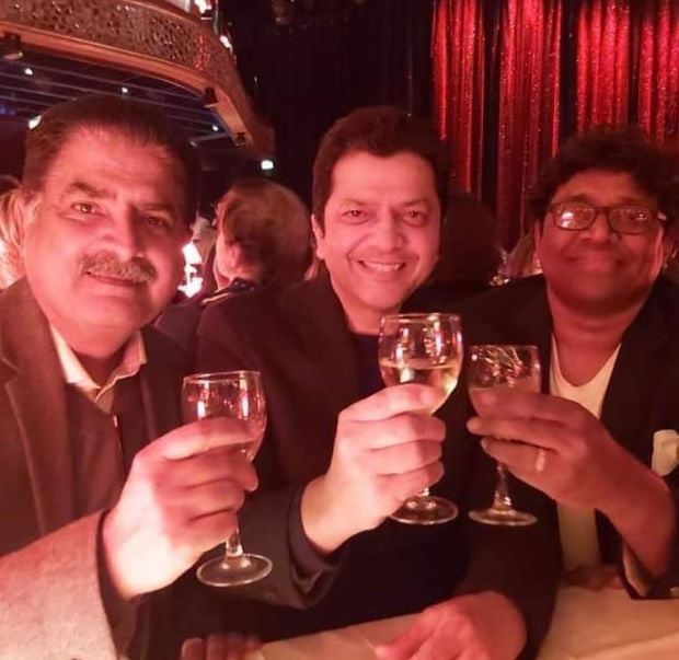 A photo of Pankaj Bhargava holding a glass of champagne