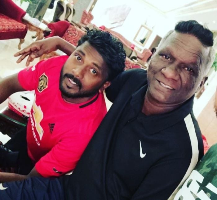 A photograph of Pradeep with I. M. Vijayan