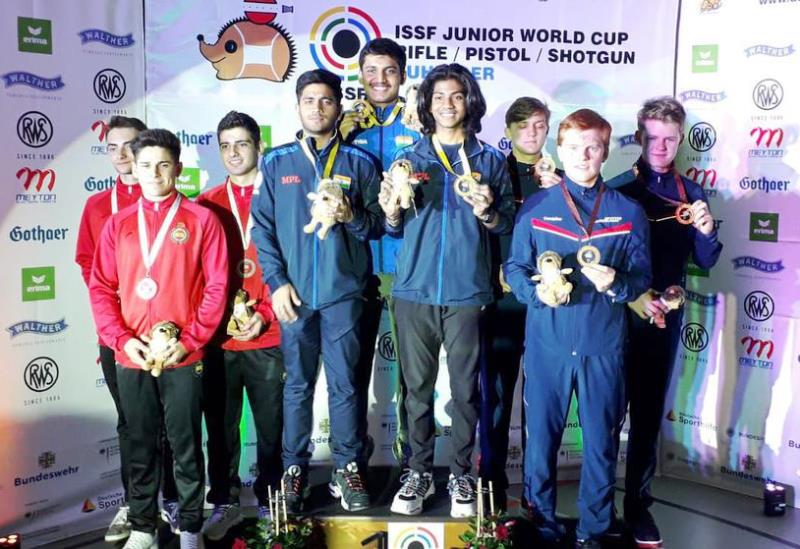 Rudrankksh Patil, Paarth Makhija, and Umamahesh Maddineni standing on the podium