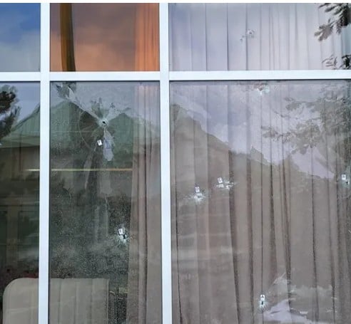 A picture of multiple bullets fired on the window of Kap