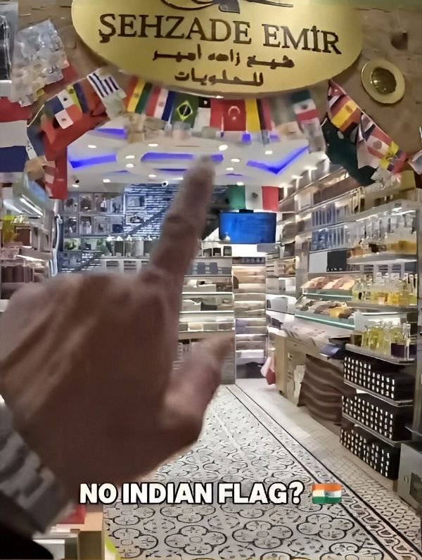 A still from Malik Swashbuckler's video in which he confronted a shopkeeper about the missing Indian flag