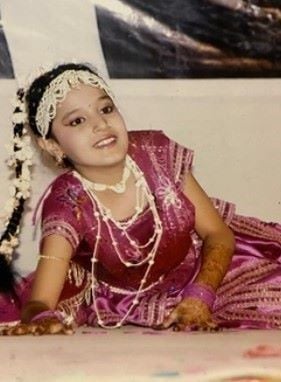 A young Ayushi Khurana dancing on stage