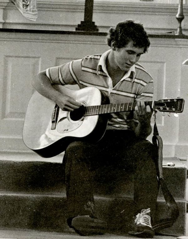 A young Mike Pence playing the guitar in a Hanover College chapel