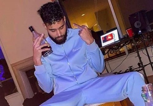 AP Dhillon holding a bottle of alcohol