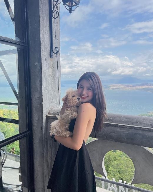 AZ Martinez holding a Toy Poodle