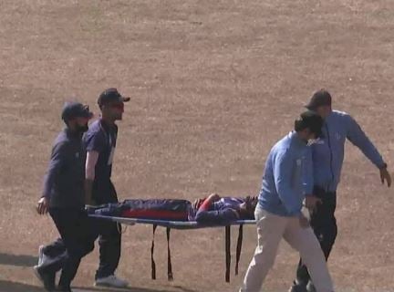 Aarif Sheikh being taken out of ground on a stretcher