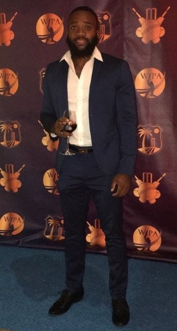 Aaron Jones holding a glass of red wine