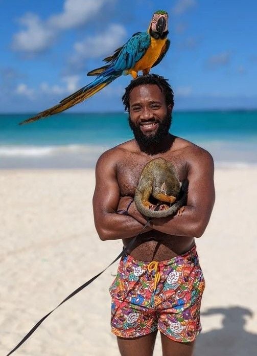 Aaron Jones posing with an exotic animal and bird