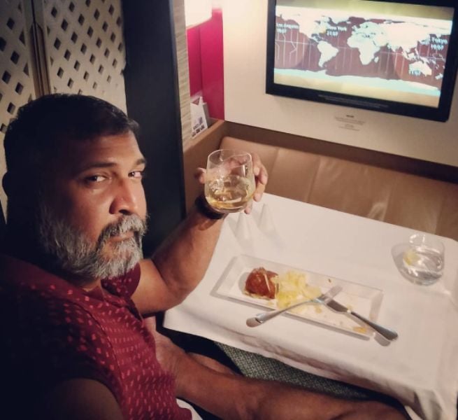 Adithya Menon holding a glass of whiskey