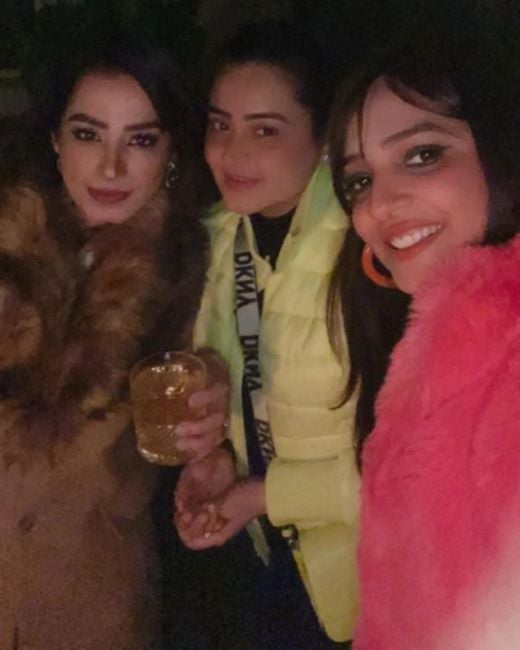Aditi Nagpal Girotra (extreme left) holding a glass of alcohol