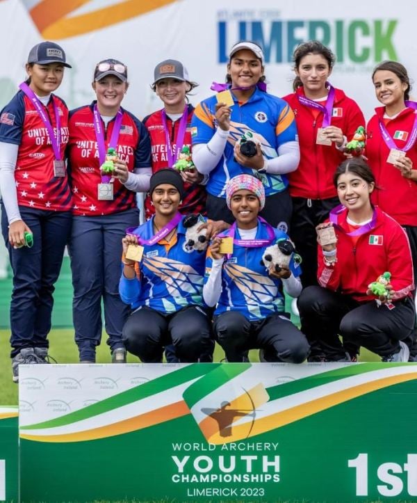 Aditi Swami (centre; seated) after winning gold at the 2023 World Archery Youth Championships in Limerick, Ireland