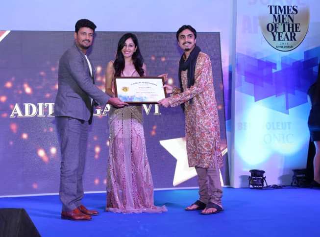 Aditya Gadhvi posing with his Times Men of the Year Award in 2018