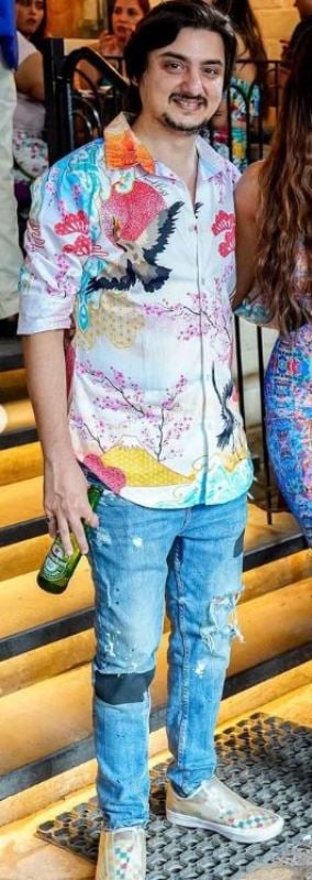 Aditya Kapadia holding a beer bottle