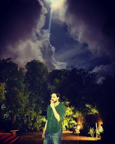 Adnan Hussain smoking a cigarette