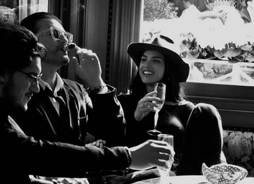 Adria Arjona holding a glass of alcohol