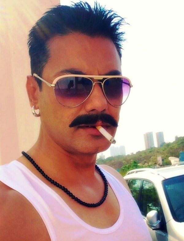 Afzaal Khan smoking a cigarette