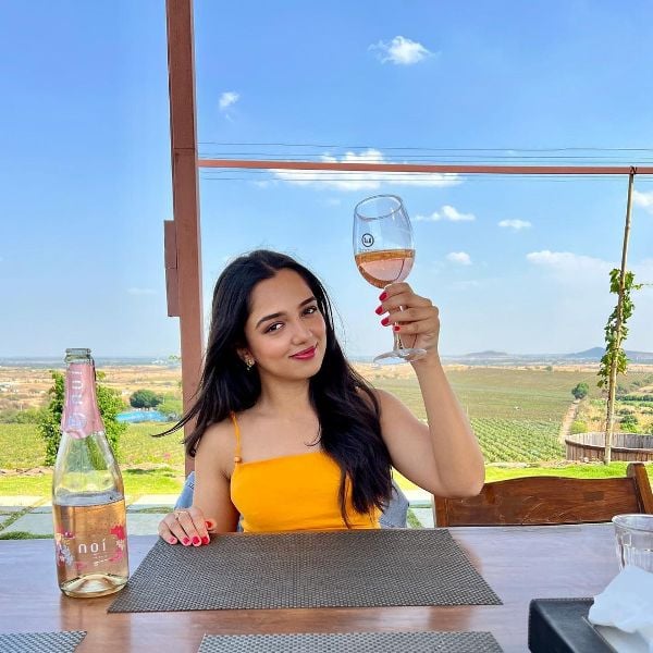 Ahsaas Channa while holding a glass of wine