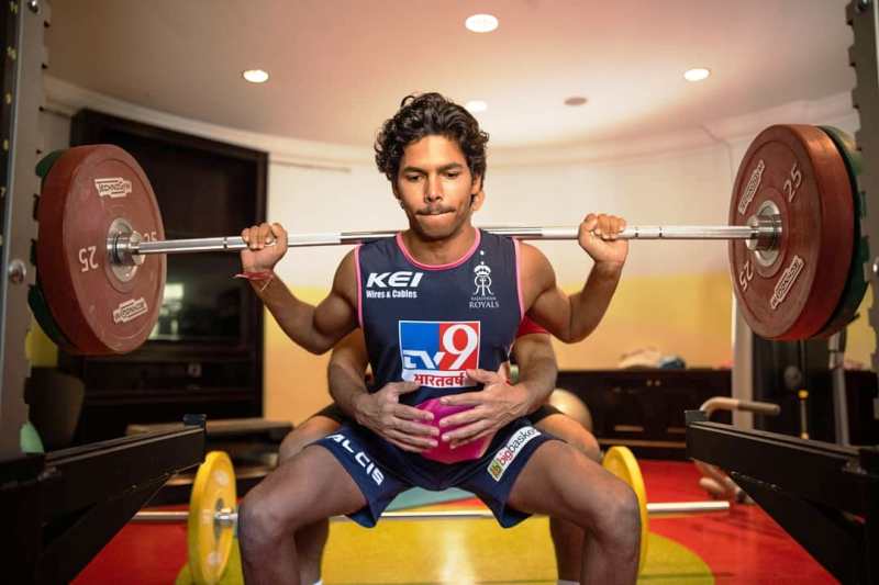 Akash Singh performing squats in the gym