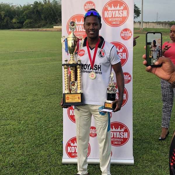 Akeal Hosein posing with awards in Trinidad and Tobago