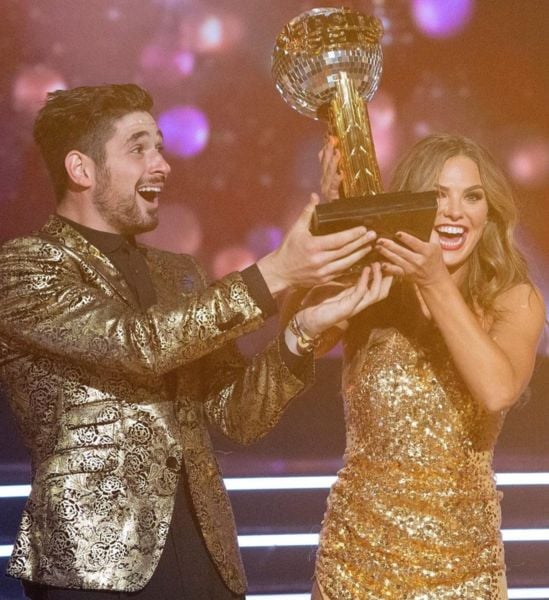 Alan Bersten and his dance partner Hannah Brown posing with the winning trophy of the 28th season of 
