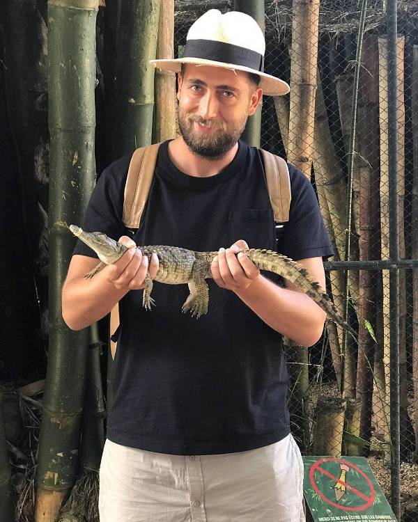 Alaudin Hamiti while holding a baby crocodile