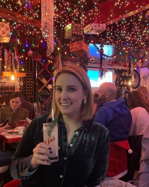 Alex Wilson holding a glass of alcohol