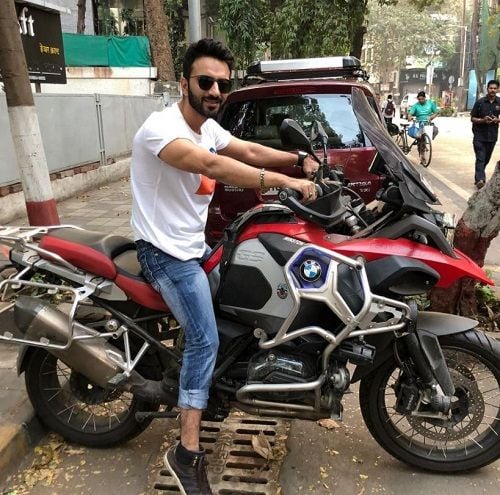 Ali Merchant sitting on his motorcycle