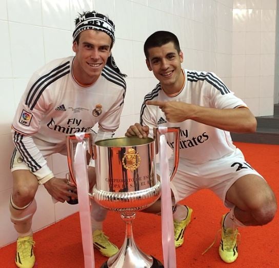 Alvaro Morata with Gareth Bale (left) after winning a trophy for Real Madrid