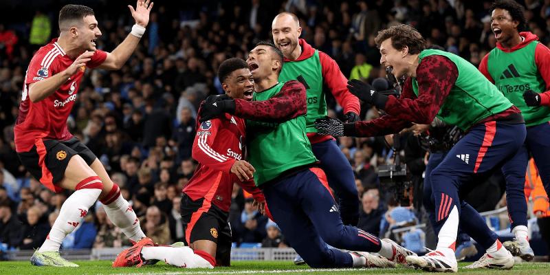 Amad Diallo celebrating with his teammates after scoring the winning goal against Manchester City