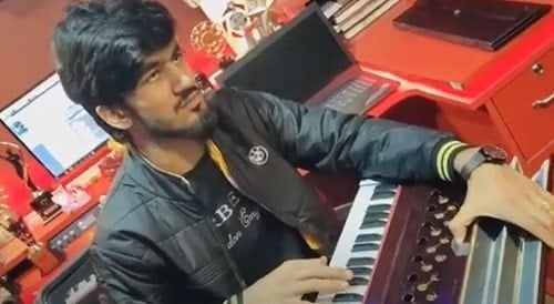 Aman Jaji playing harmonium