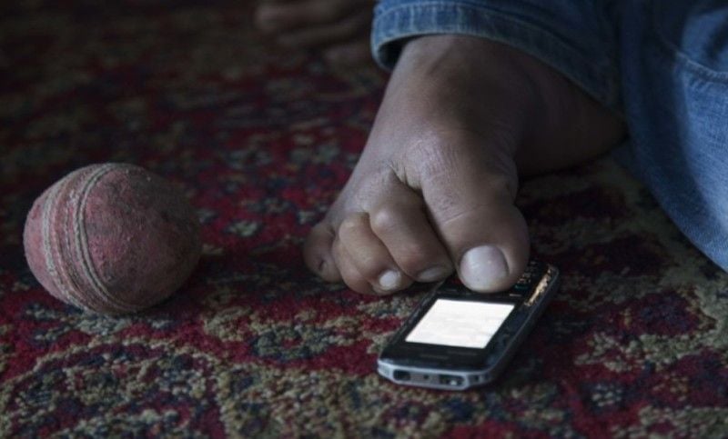 Amir Hussain Lone typing a message using his leg