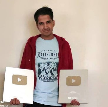 Amit Sharma posing with YouTube silver play buttons
