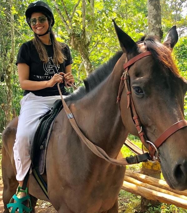 Amritha Suresh riding a horse