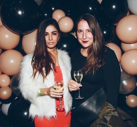 Amy Aela holding a glass of wine